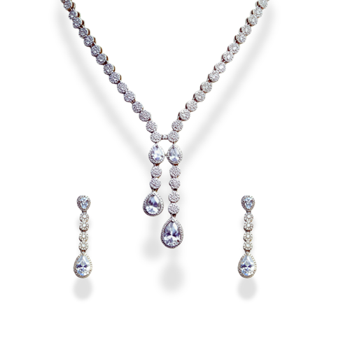 American Diamond Teardrop Set, A dazzling ensemble tailored for cocktail nights, formal galas, weddings, or high-profile celebrations. This refined set adds an air of glamour to evening gowns, sarees, or chic contemporary outfits. Whether you're attending a reception or walking into a luxurious dinner party, its brilliance ensures you remain the center of attention with effortless grace. Material & Care Material: Gold Alloy, sterling silver, silver, brass, aluminium Plating: Silver Plating Stones: AAA-Grade