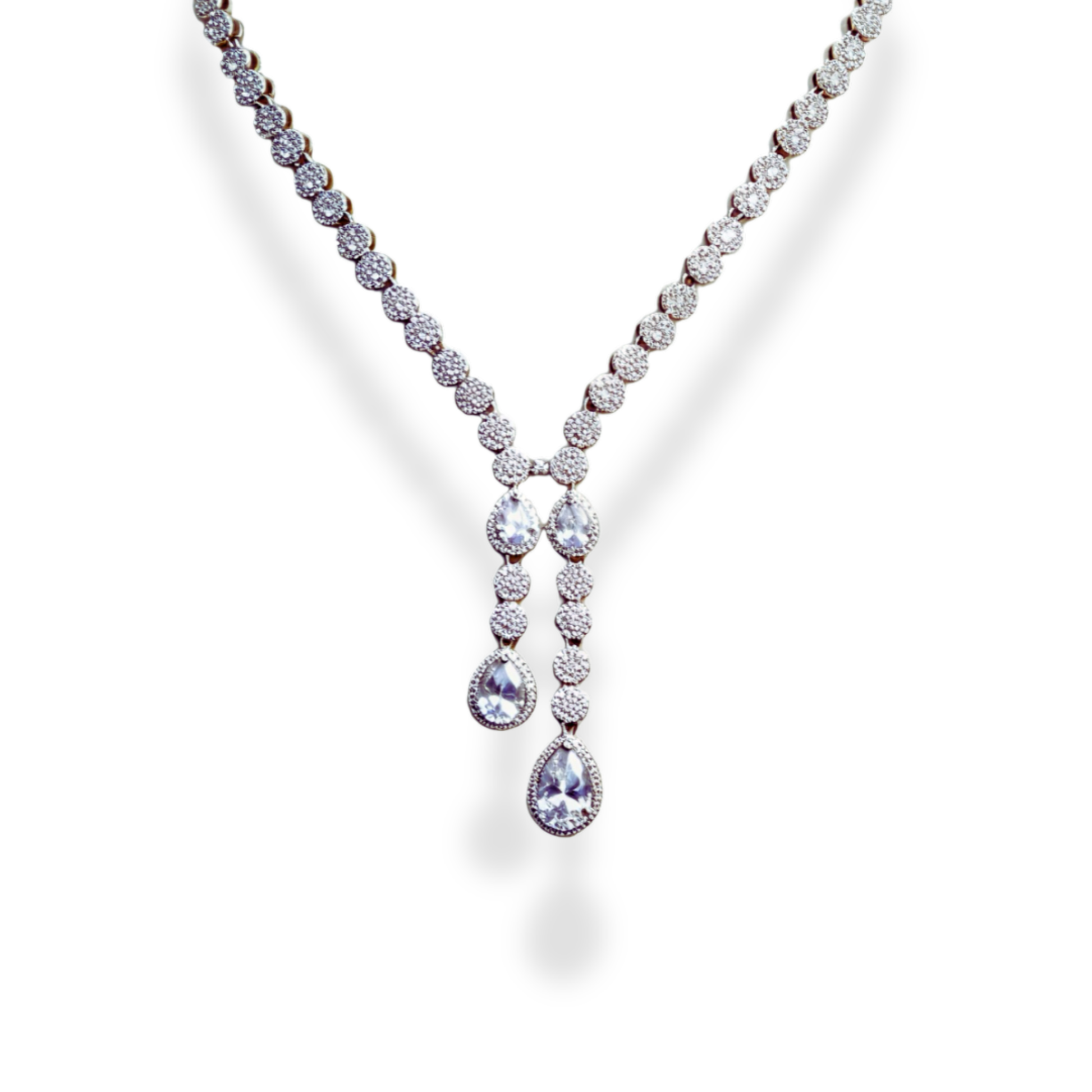 American Diamond Teardrop Set, A dazzling ensemble tailored for cocktail nights, formal galas, weddings, or high-profile celebrations. This refined set adds an air of glamour to evening gowns, sarees, or chic contemporary outfits. Whether you're attending a reception or walking into a luxurious dinner party, its brilliance ensures you remain the center of attention with effortless grace. Material & Care Material: Gold Alloy, sterling silver, silver, brass, aluminium Plating: Silver Plating Stones: AAA-Grade